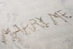 Marriage propsal written in sand
